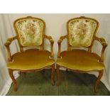 A pair of upholstered armchairs on four cabriole legs, 96 x 59 x 50cm each