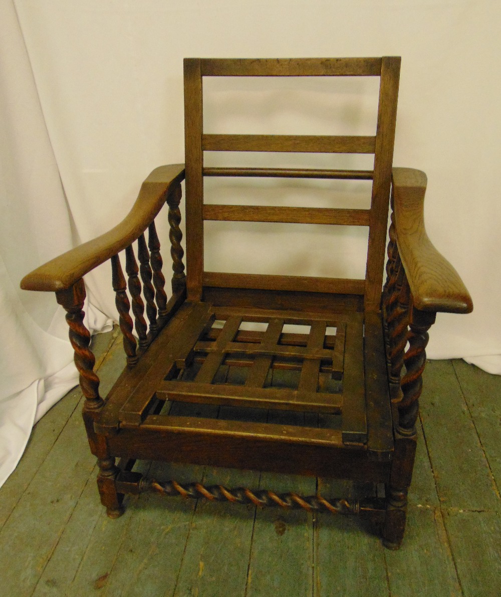 An early 20th century oak steamer chair with barley twist columns to the sides and base, 94 x 72 x