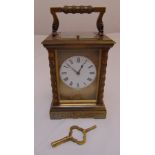 A French repeating carriage clock of customary form with white enamel dial and Roman numerals,