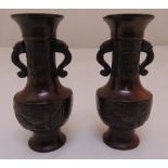 A pair of Chinese miniature bronze vases with mask side handles on flared circular bases, 11cm (h)