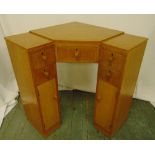 An Art Deco blonde oak corner desk with seven drawers and turned handles, 74 x 65.5 x 63cm