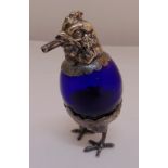 A continental white metal and blue glass cigar lamp in the form of a chicken with pull off head,