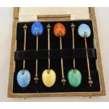 A cased set of six silver gilt and coloured enamel coffee spoons, Birmingham 1927
