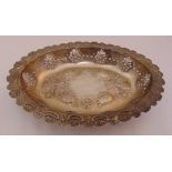 A hallmarked silver oval dish, pierced sides and chased with flowers, fruit and scrolls,