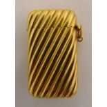 Gold vesta case, tested 18ct, the ribbed sides and hinged cover with suspensory loop