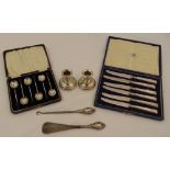 A quantity of silver to include dwarf candlesticks, cased coffee spoons, cased tea knives, a