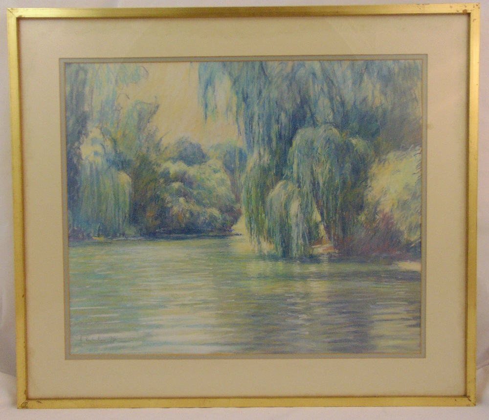 A framed and glazed pastel of a lake and trees, indistinctly signed bottom left, 54 x 65.5cm