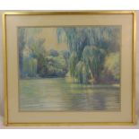 A framed and glazed pastel of a lake and trees, indistinctly signed bottom left, 54 x 65.5cm