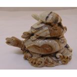 A carved hardstone paperweight in the form of three graduated turtles,