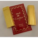 Two must de Cartier gold plated cigarette lighters