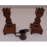 A pair of Arts and Crafts oak candlesticks and an Arts and Crafts hand hammered copper miniature
