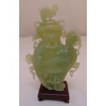 A Chinese carved green jadeite vase and cover in the form of a mythological bird on square