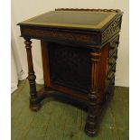 A Victorian oak Davenport of customary form with hinged leather inset top and four side drawers with