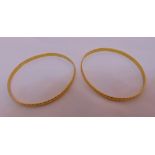 Two Middle Eastern gold bangles, tested 21ct, approx total weight 28.1g