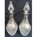 A pair of cut glass decanters with drop stoppers and silver collars, 39cm (h)