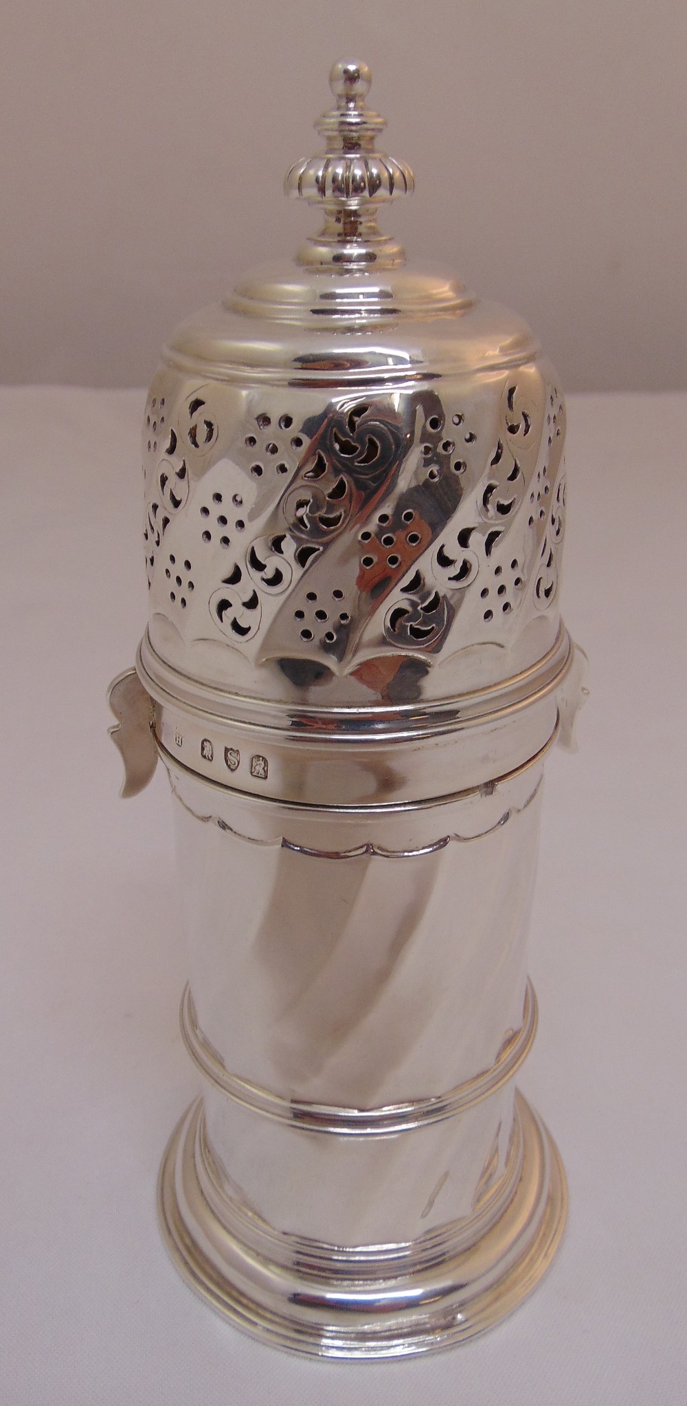 A Victorian Britannia standard silver sugar caster, cylindrical spirally fluted, the pierced and