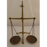 A brass beam scales with copper pans and suspensory chains by Doyle & Sons, 6.5cm (h)