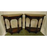 A pair of oak side tables, the angled tops with baluster supports on four rectangular legs, 72 x