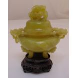 A Jadeite corot with cover on four carved legs, the domed pull off cover with carved finial on