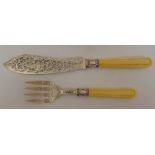 A pair of Victorian hallmarked silver fish carvers, the scroll pierced blades engraved with dolphins