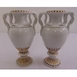 A pair of Meissen classical style vases of baluster form with serpent side handles on raised