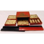 An early 20th century Mah-jong set in lacquered wooden case to include counters and rests, 18cm (h)