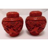 A pair of cinnabar lacquer ginger jars with detachable covers, the bodies carved with prunus