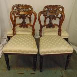 A set of four Victorian mahogany dining chairs with scroll pierced backs on turned tubular legs