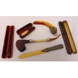 A quantity of collectables to include a paper knife, cheroot and cigarette holders in fitted cases