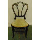 A Victorian ebonised and mother of pearl inlaid childs chair with upholstered seat on four