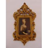 A sepia photograph of a woman in costume within a scroll pierced gilded metal frame 8.5 x 5.5 cm