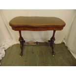 A late Victorian mahogany games table, shaped rectangular, the hinged top revealing a baize top, all