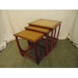 A 1960s nest of three tables one with tile top, 51cm (h)