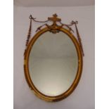 A Regency style oval wall mirror with rope twist borders and husk swags, A/F, 90 x 52cm