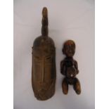 A carved West African ceremonial mask, 59cm (h) and a carved hardwood female fertility figurine with