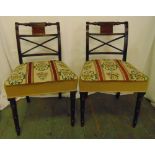 A pair of Regency mahogany dining chairs with upholstered tapestry seats on turned tubular legs