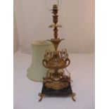 A gilt metal table lamp in the form of a classical urn on rectangular marble base to include silk