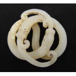 A Chinese Qing Dynasty white jade pendant in the form of interlocking serpents, 6cm (dia)