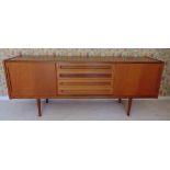 A teak rectangular mid 20th century sideboard with four drawers and two cupboards on four tapering