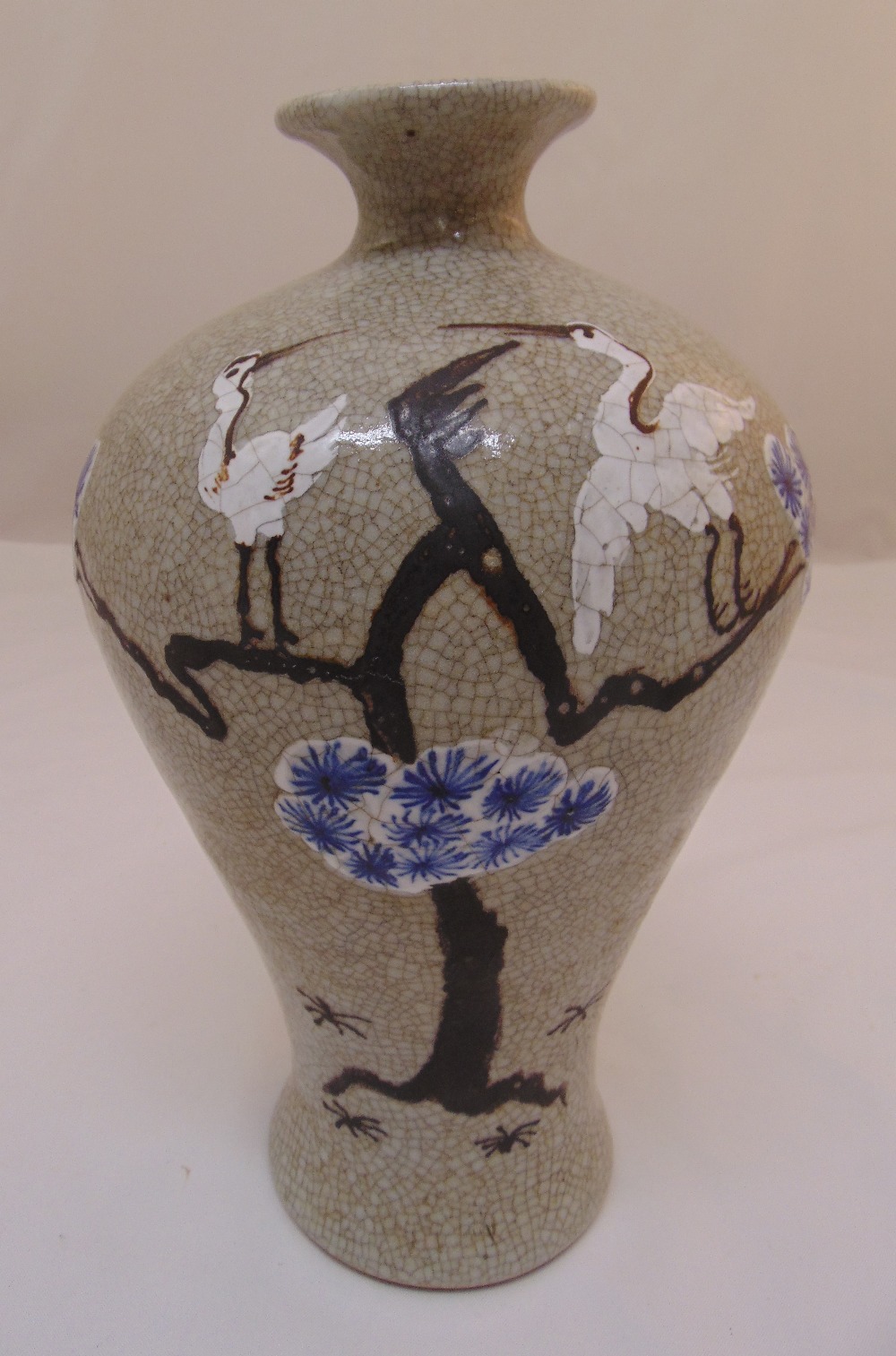 An early 20th century Chinese crackle glaze Meipin vase decorated with birds and trees, 33cm (h)