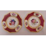 A pair of 19th century cabinet plates decorated with flowers and gilded borders, 23cm (dia)