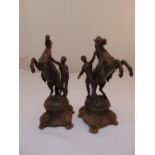 A pair of spelter models of Marly horses and trainers on shaped raised bases, 35cm (h)