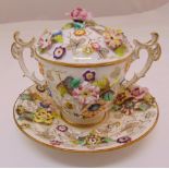 A Meissen style two handled cup, cover and saucer decorated with Deutche Blumen, 13cm (h)