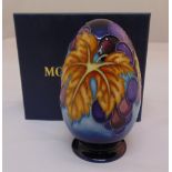 Moorcroft porcelain egg decorated with grapes and vine leaves, marks to the base, in original