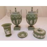 A pair of Wedgwood green Jasperware two handled urns and covers, one cover crack to rim, 32cm (h), a