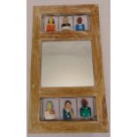 A Brazilian rectangular wooden folk art mirror with hand painted carved figurines, 79.5 x 44.5cm