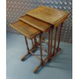 A nest of three rectangular mahogany tables with turned supports and stretchers on angled feet, 65 x
