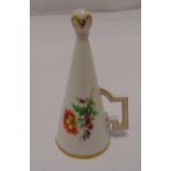 A Meissen porcelain candle snuffer of conical form decorated with flowers and leaves, crossed