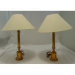 A pair of brass table lamps of cylindrical form on raised cylindrical bases, to include shades, 62cm