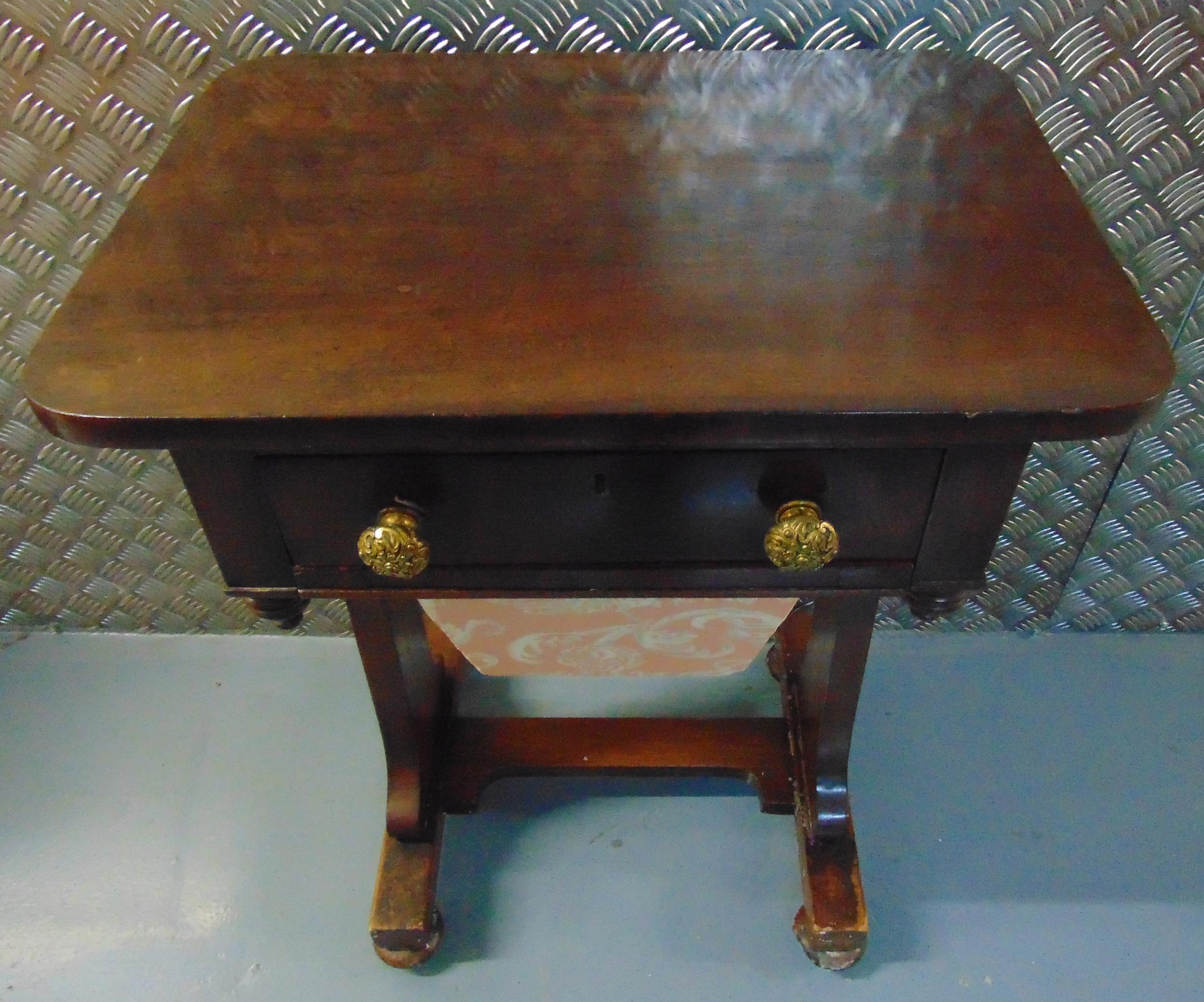 A rectangular mahogany sewing table, single drawer with brass handles on scrolling bracket supports,